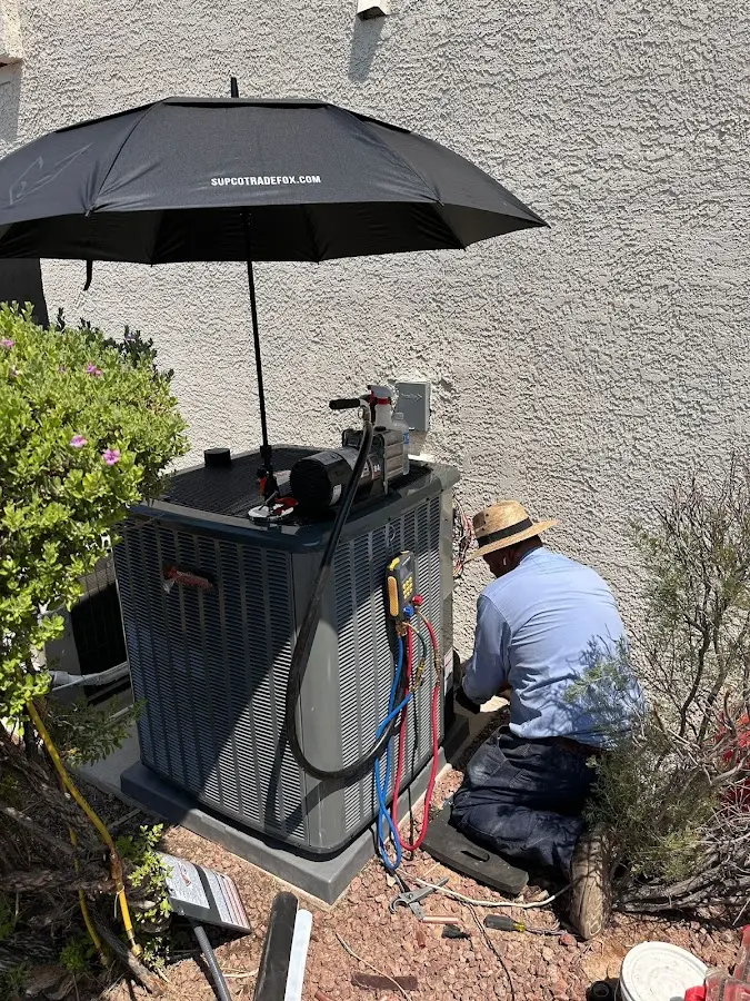HVAC technician performing outdoor AC maintenance in Riverdale Park
